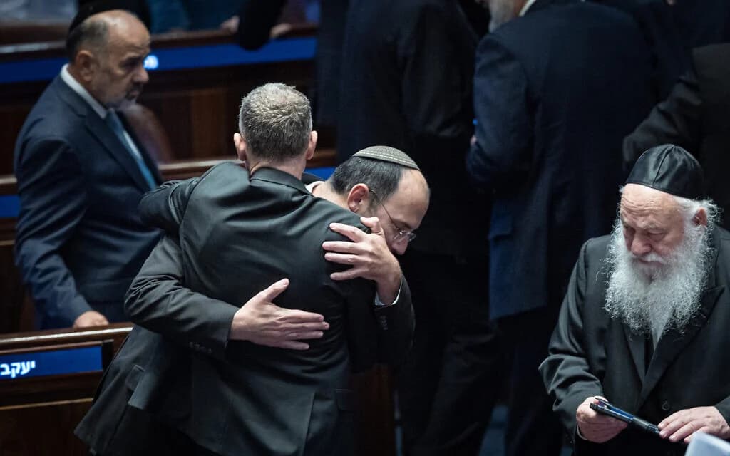 MK Simcha Rothman celebrates with Justice Minister Yariv Levin after the vote to weaken the attorney general's powers