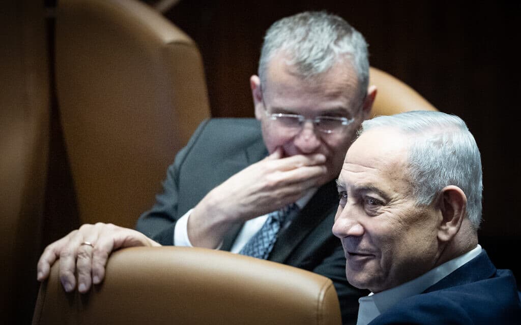 Prime Minister Benjamin Netanyahu and Justice Minister Yariv Levin talk in the Knesset hours before parliament dispersed