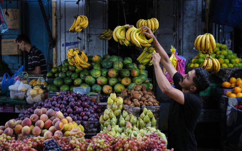 A Palestinian vendor arranges fruit at a market in the Al-Shati refugee camp in Gaza City