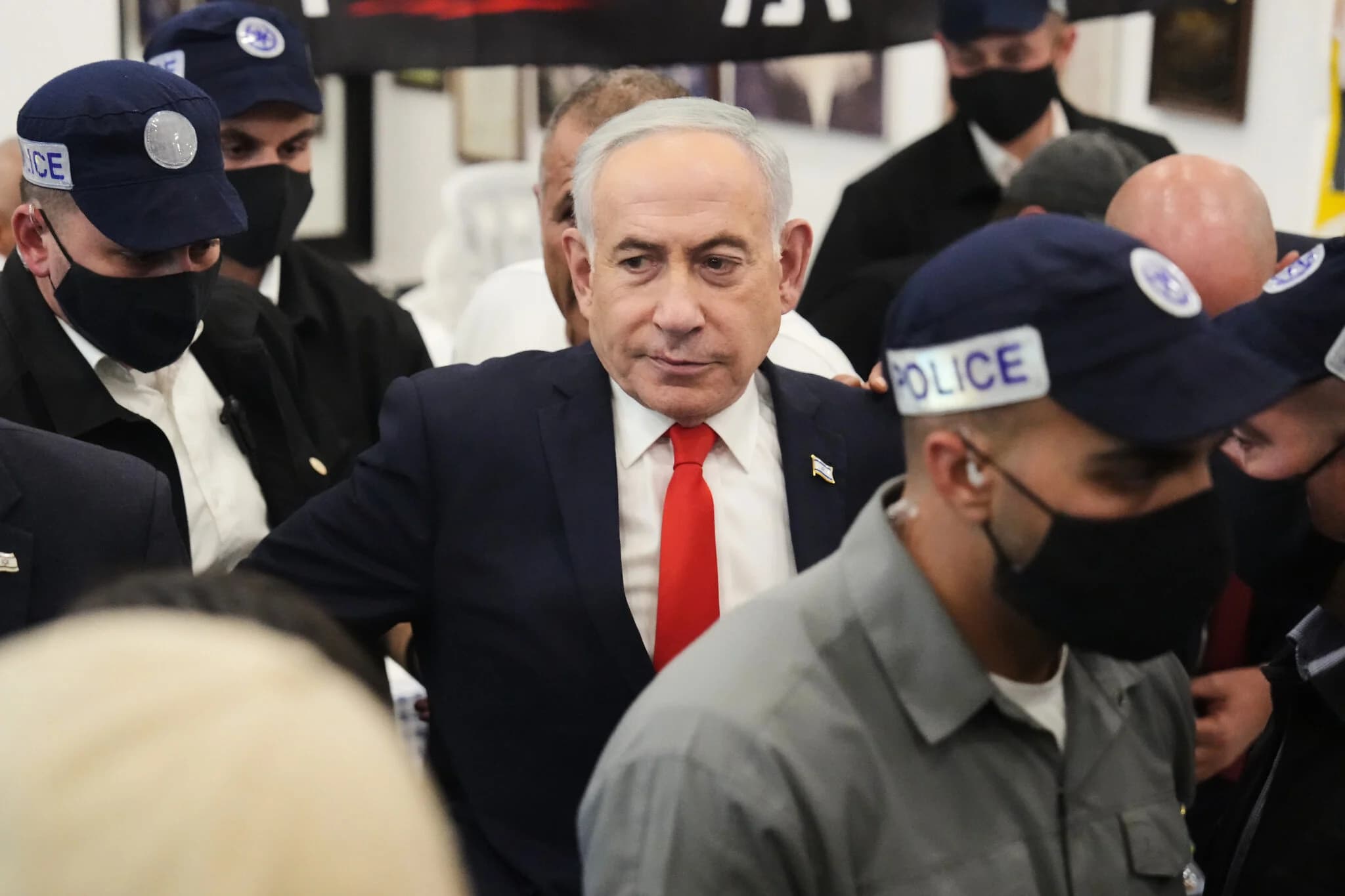 Prime Minister Benjamin Netanyahu, surrounded by security personnel, campaigns at a market in Tel Aviv