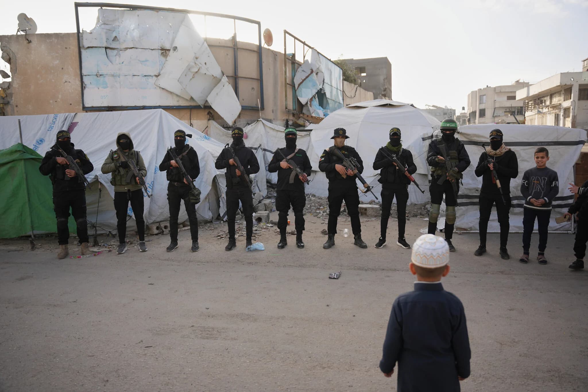 Armed members of Hamas and Islamic Jihad greet people gathering for Eid al-Fitr prayers in Gaza City