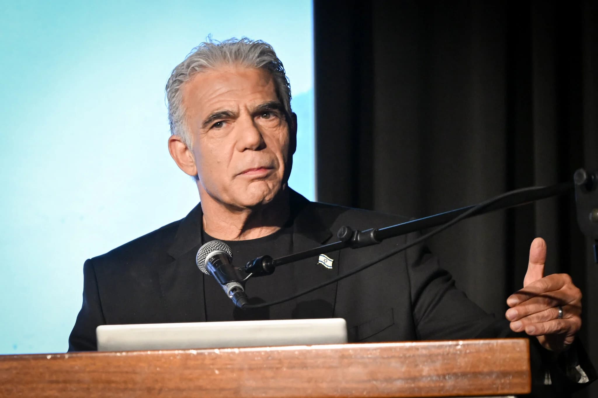 Opposition leader Yair Lapid speaks at a conference